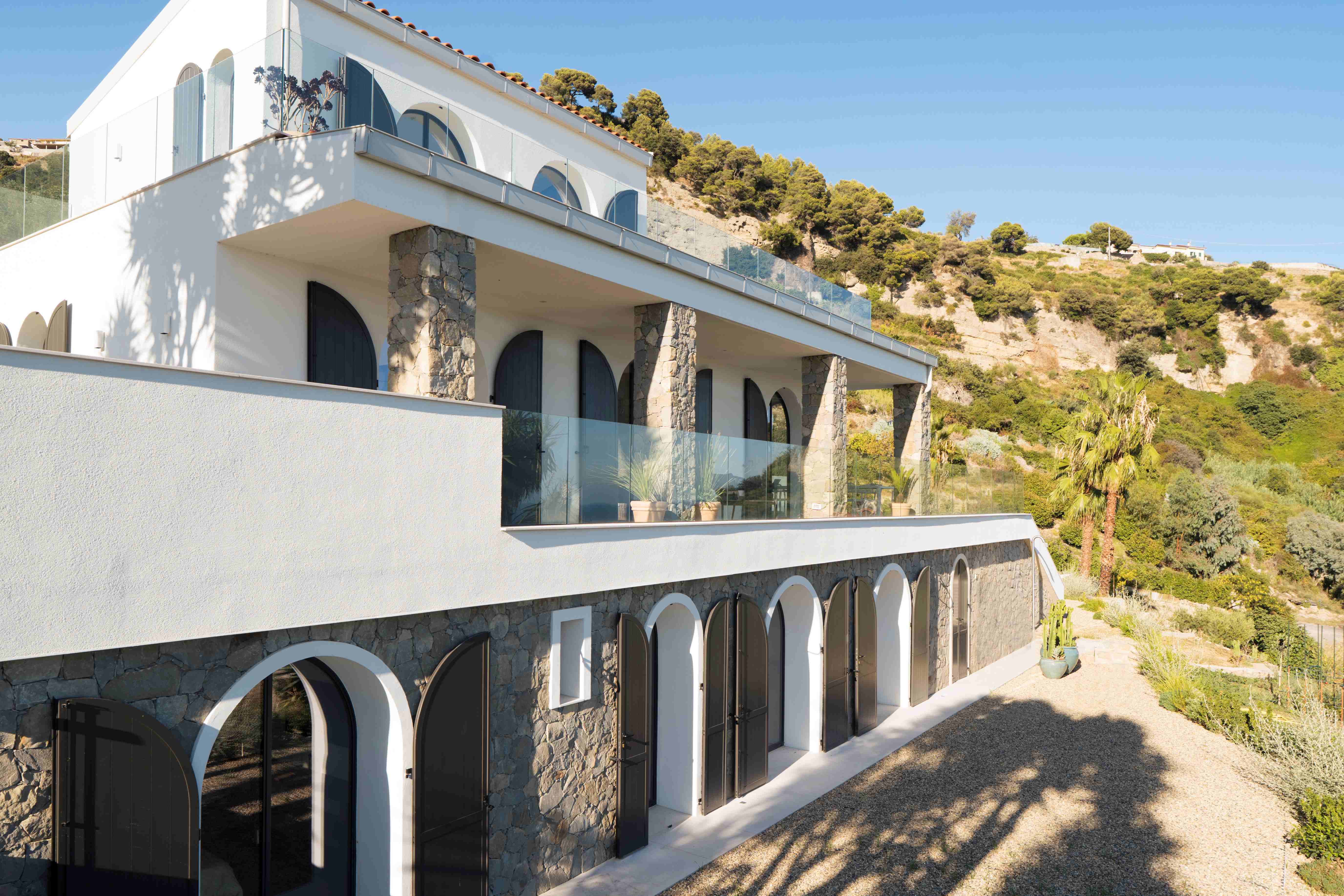 Villa facade with arched windows and natural stone